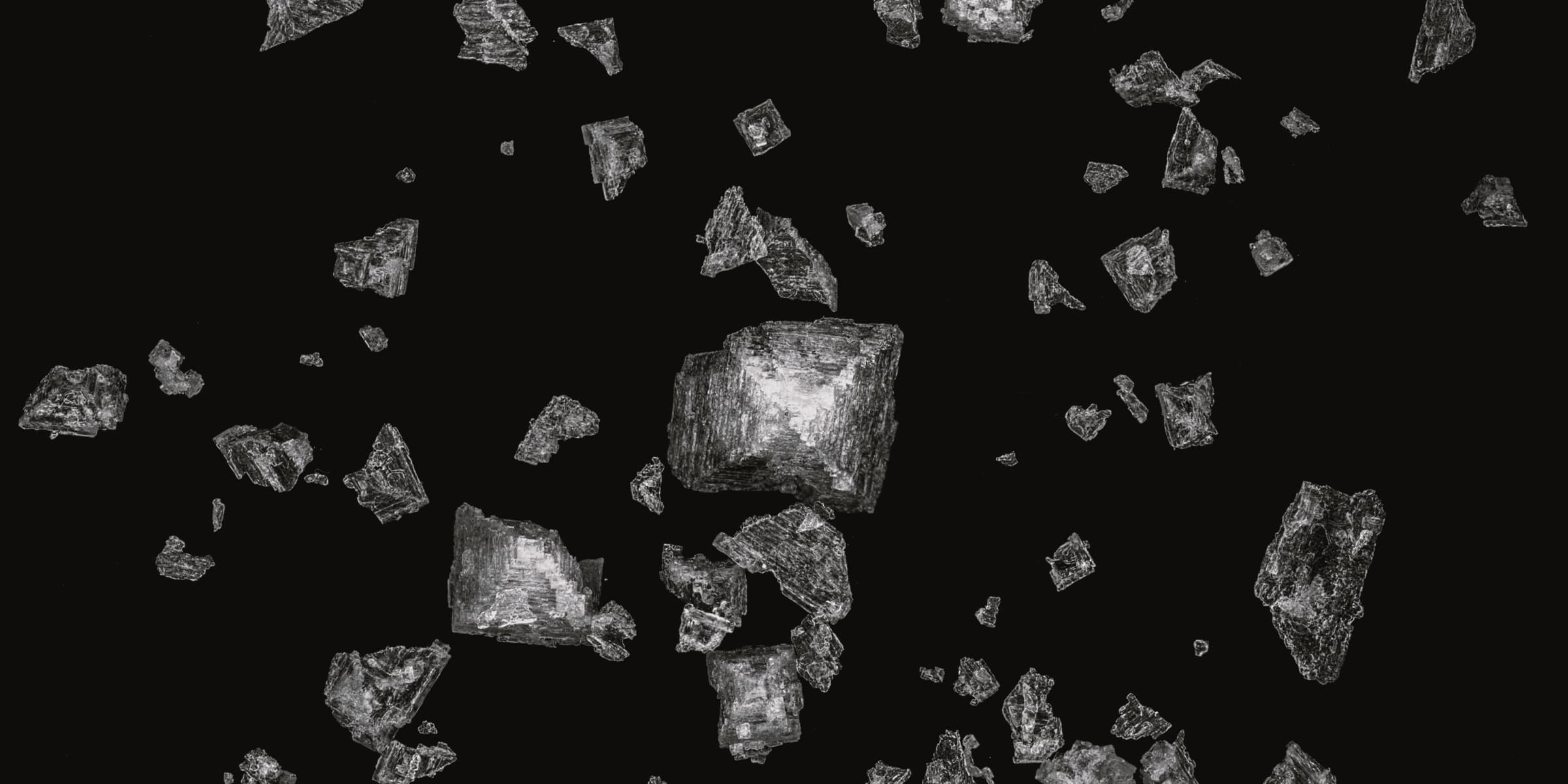 Shards of broken crystal on a dark surface